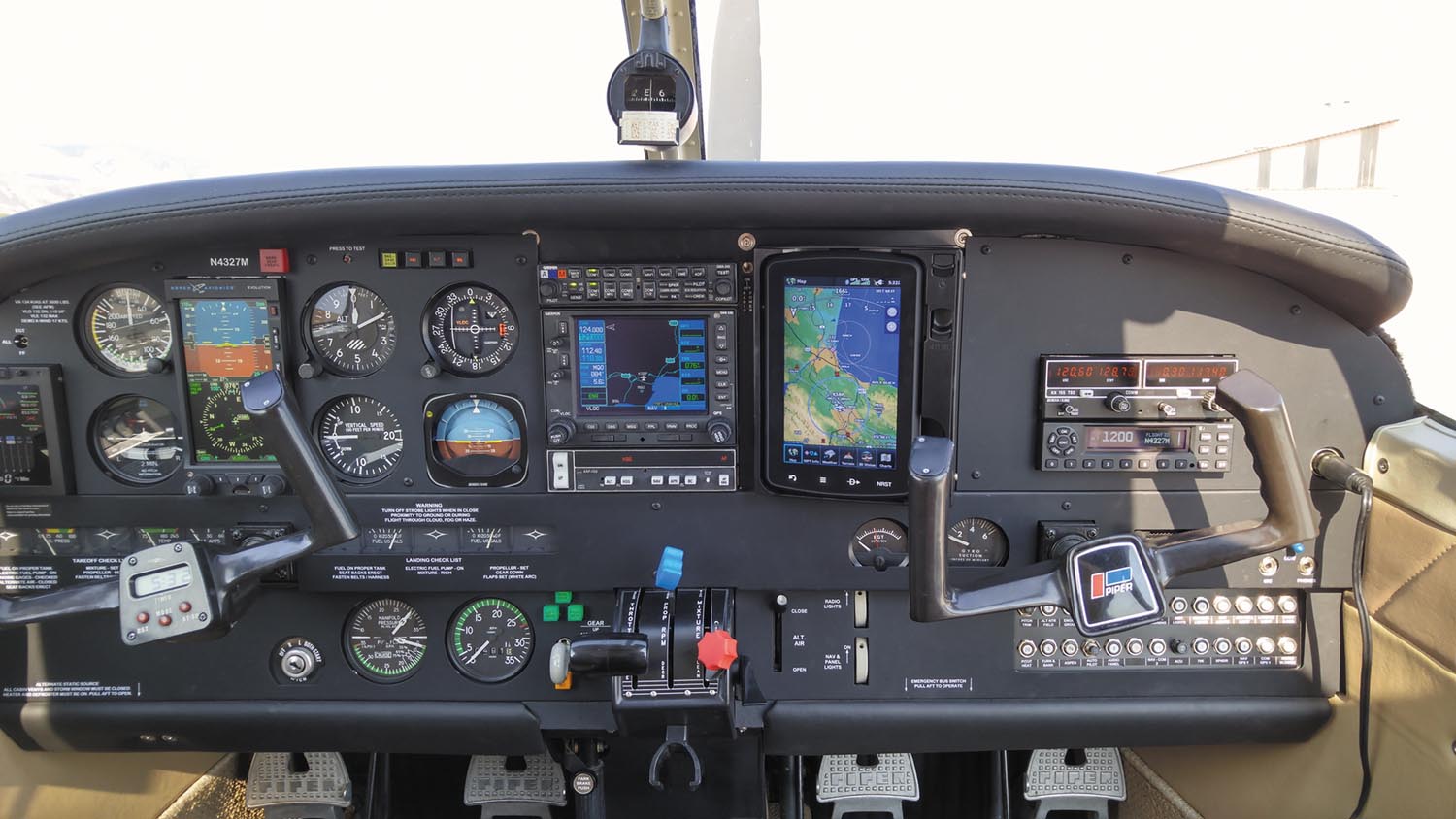 Large instrument panels, middle, accommodate all kinds of avionics retrofits. That’s an Aspen PFD, Garmin GNS 530 and dock-mounted Garmin GPS in the middle photo.